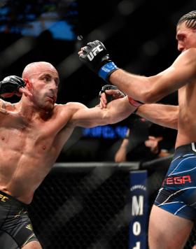 Alexander Volkanovski of Australia punches Brian Ortega in their UFC featherweight championship fight during the UFC 266 event on September 25, 2021 in Las Vegas, Nevada. (Photo by Chris Unger/Zuffa LLC)